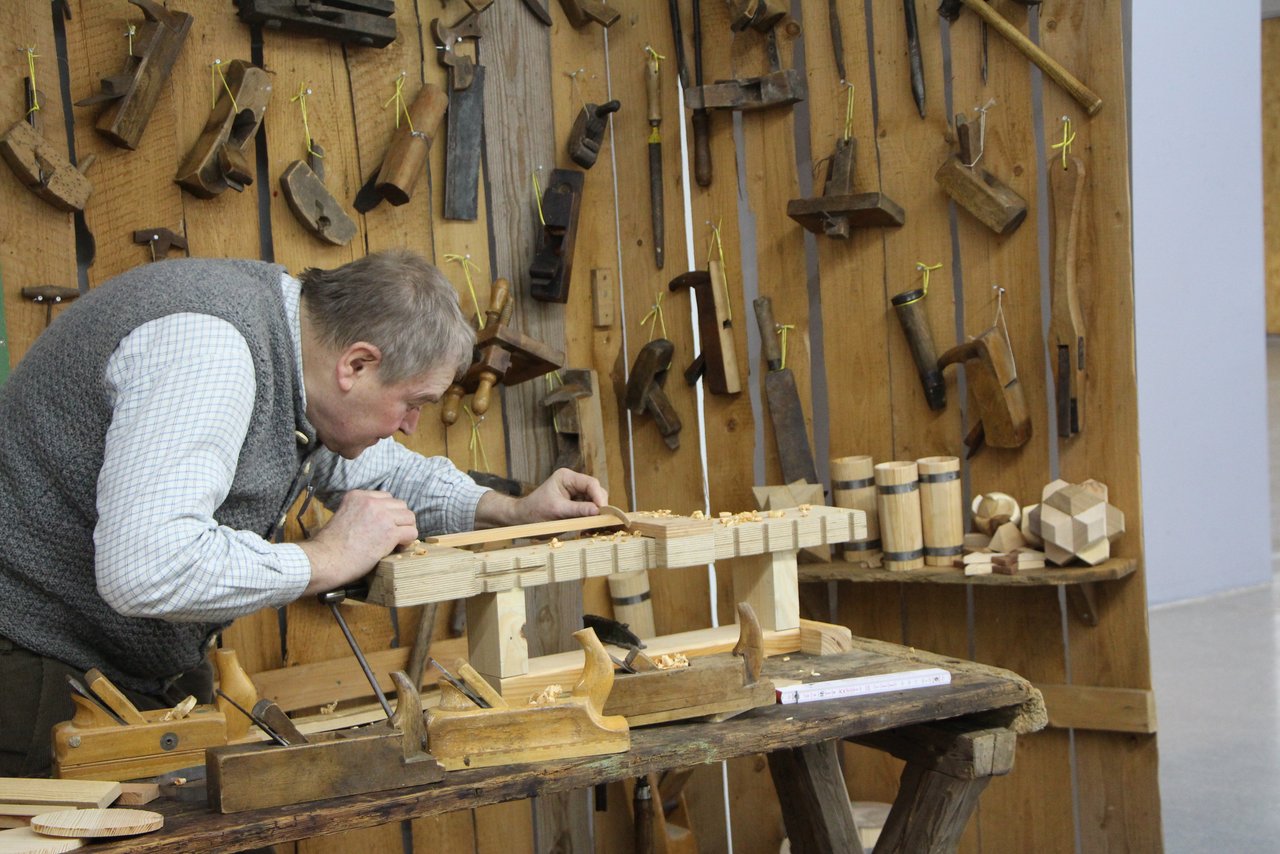 Museumsbüttner Hans Grau an der Werkbank.